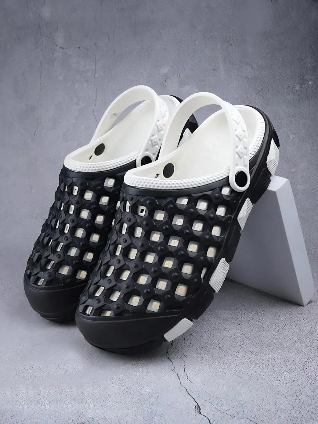 Black and white clogs on a gray background