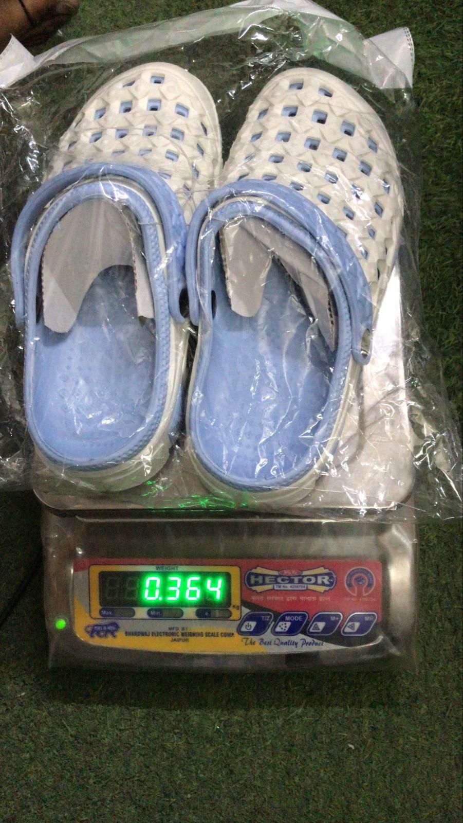 Pair of children's shoes on a digital scale with a green display.