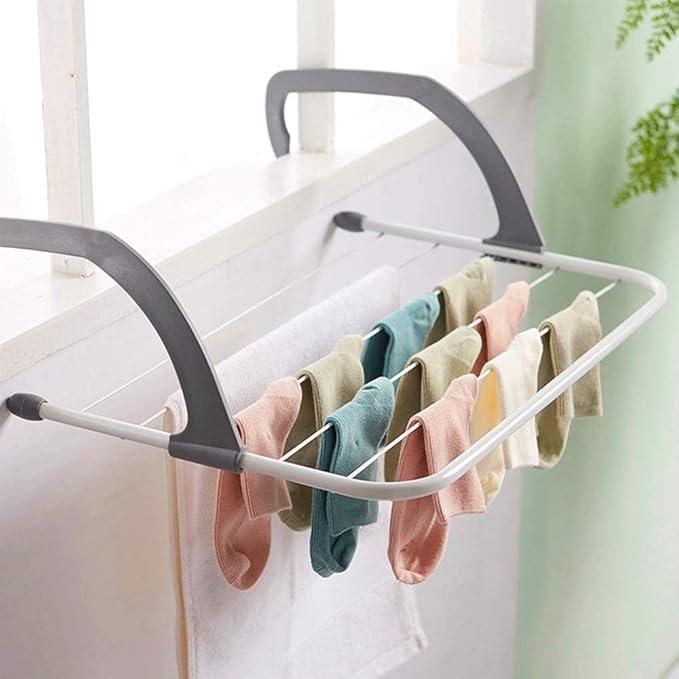 Foldable clothesline with colorful socks hanging on it against a neutral background
