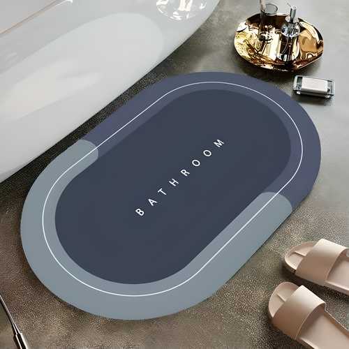Gray bath mat with 'Bathroom' text on a bathroom floor.