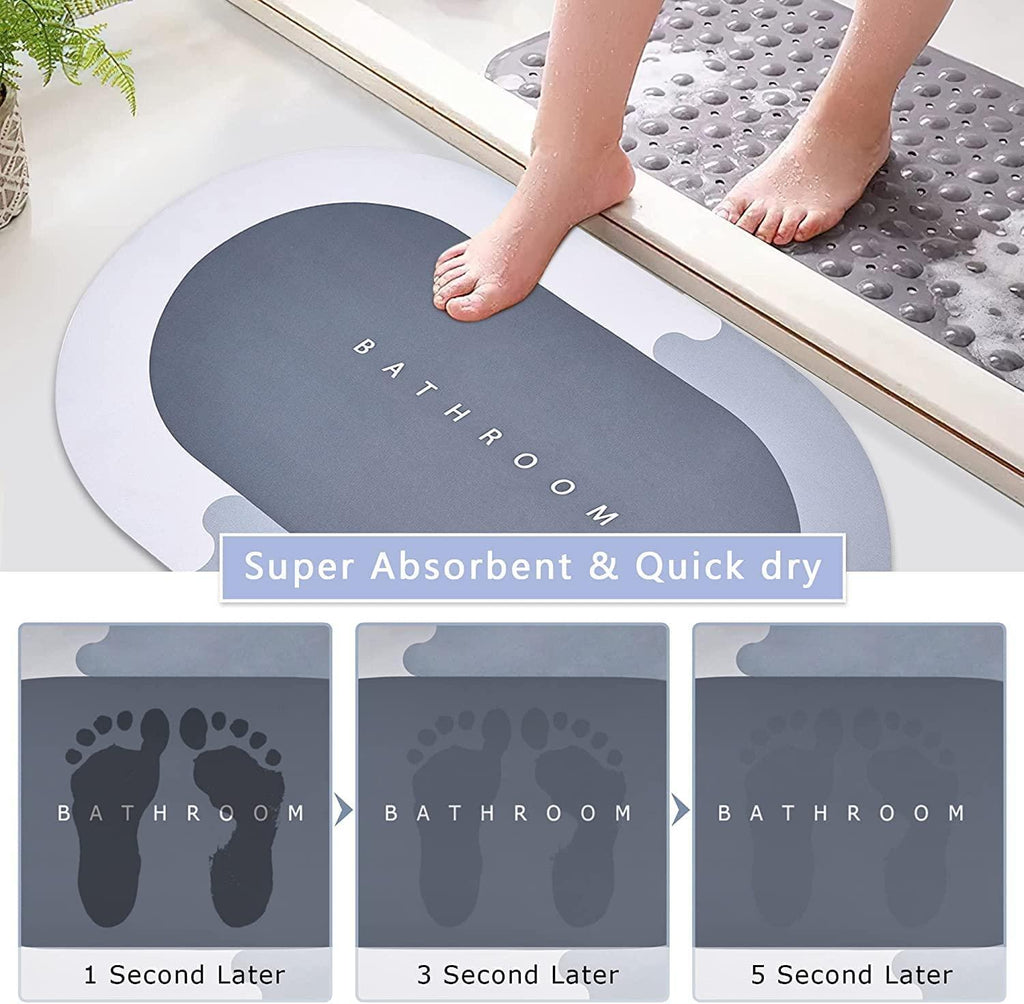 Gray bath mat with text 'Bathroom' on a white surface, showing absorbent properties with footprints.