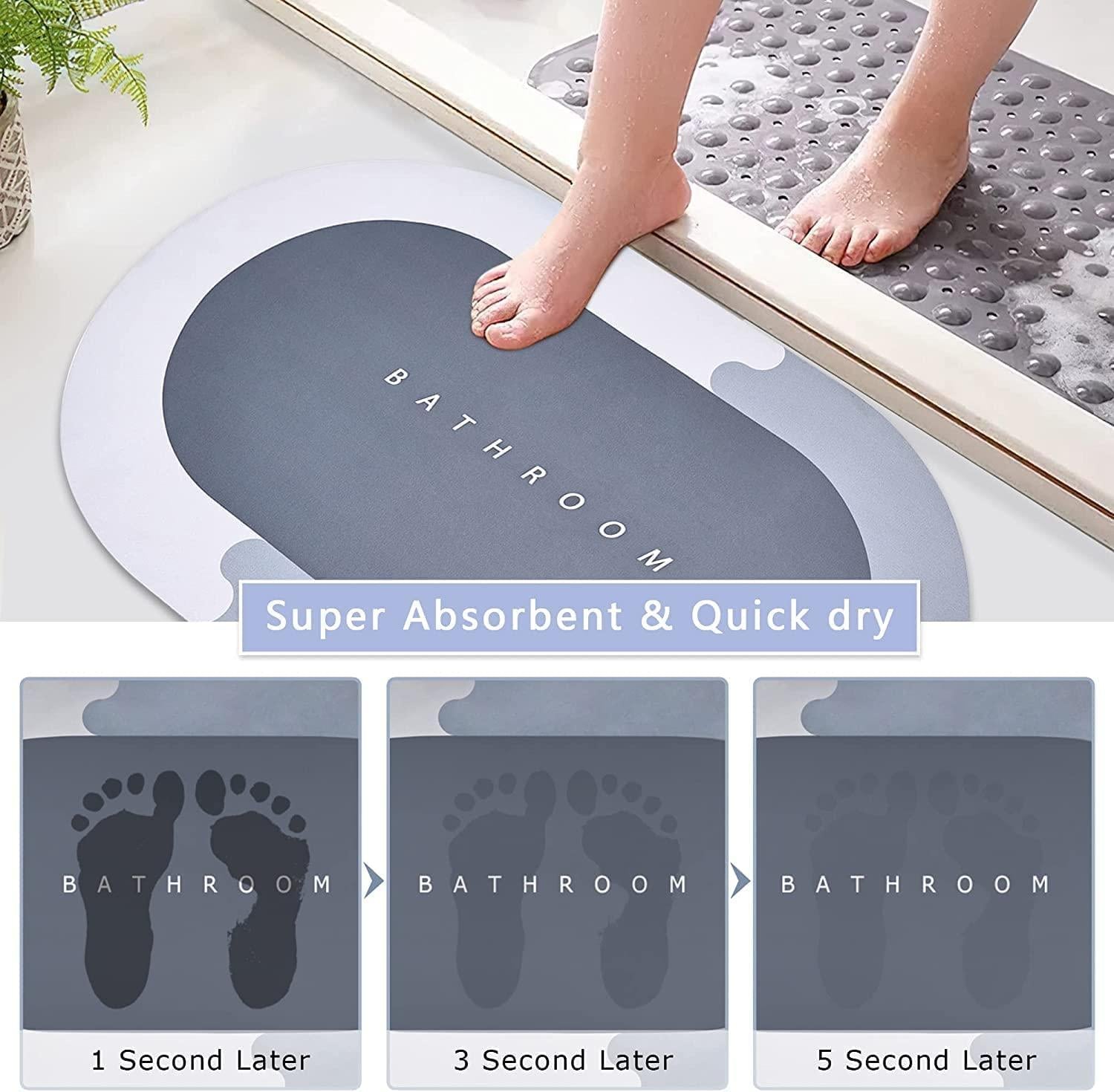 Gray bath mat with text 'Bathroom' on a white surface, showing absorbent properties with footprints.