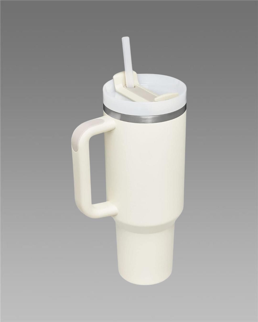 White tumbler with handle and straw on a gray background