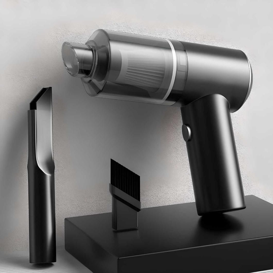 Silver handheld vacuum cleaner with attachments on a light gray background