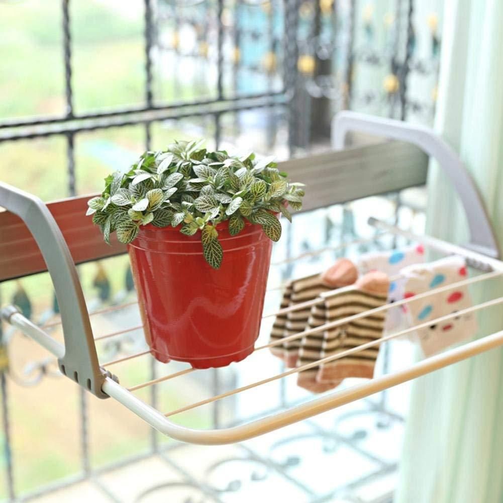 Red pot with green plant on a white metal shelf against a blurred indoor background