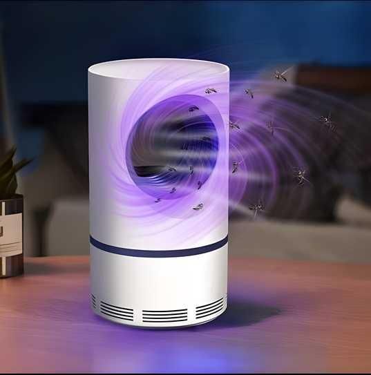 Insect repellent lamp on a table with mosquitoes attracted to it.