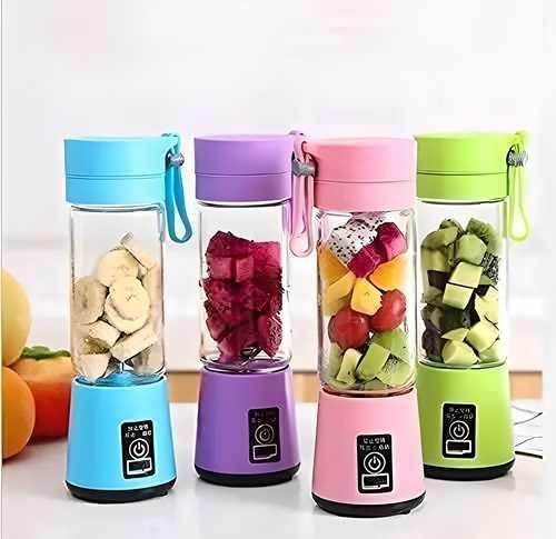 Four colorful portable blenders with fruits inside on a white background